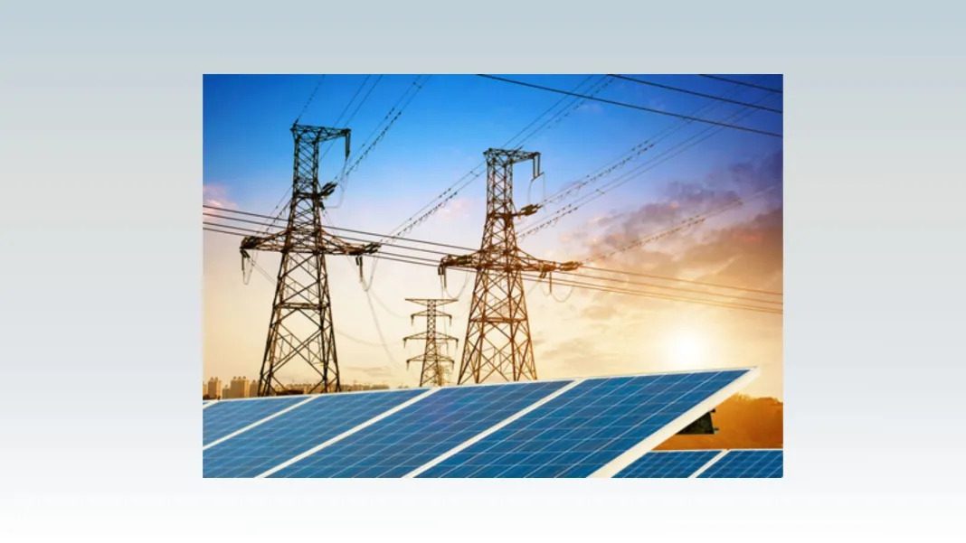 A row of blue solar panels in the foreground with tall electrical transmission towers and power lines stretching across a bright sunset sky in the background.
