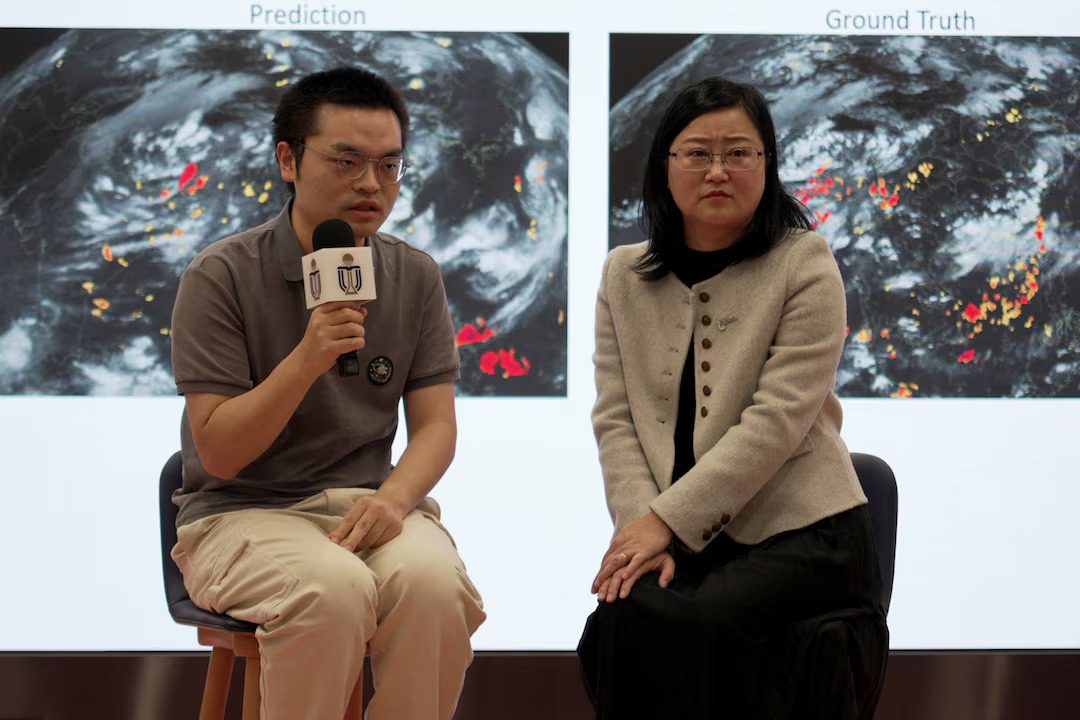 Researchers Dai Kuai (left) and Professor Su Hui (right) from the Hong Kong University of Science and Technology (HKUST) present a new AI weather model during a media briefing.