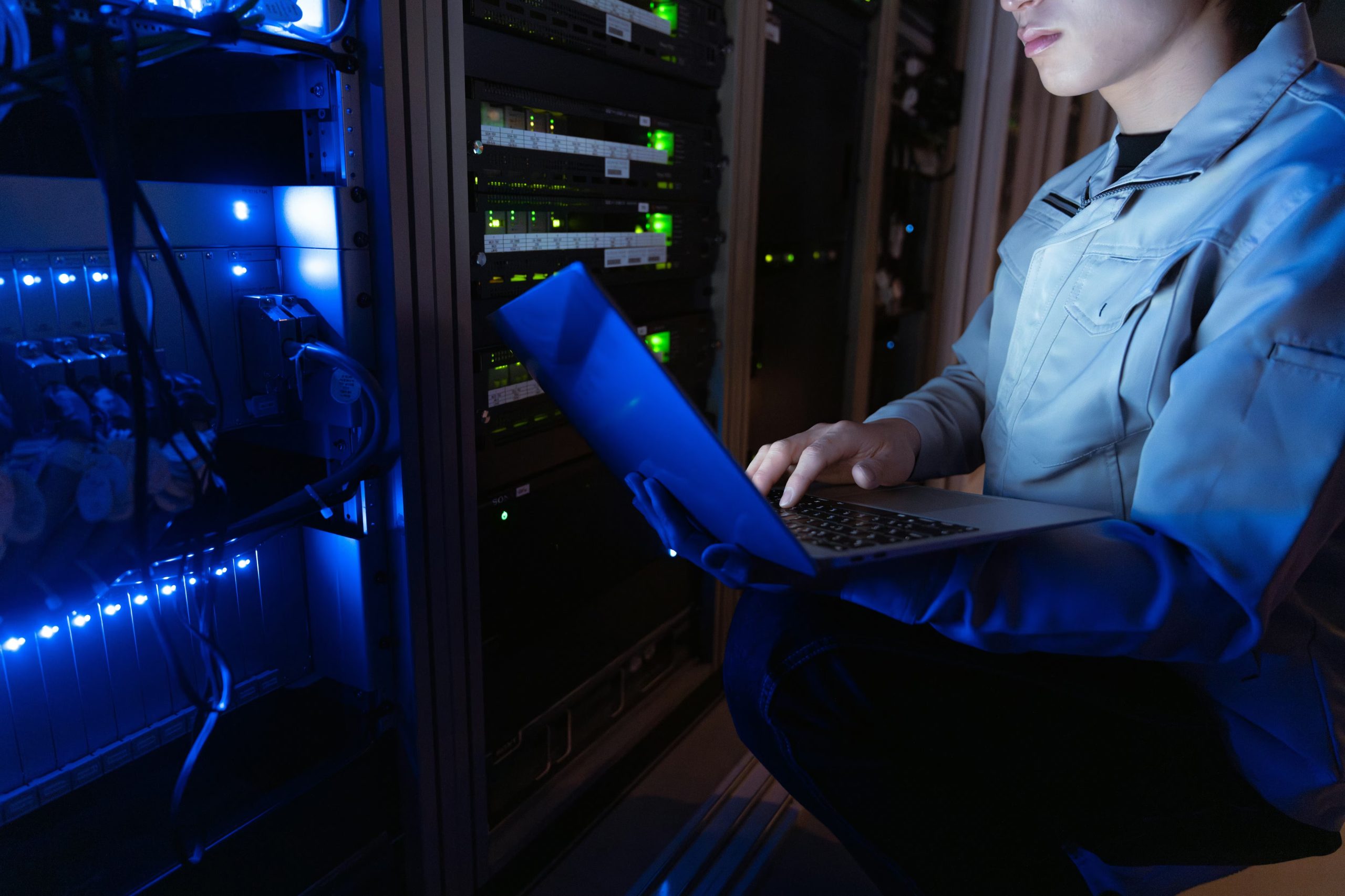 A modern cybersecurity operations center filled with large monitors displaying network activity, alerts, and data visualizations as analysts monitor threats in real time.